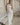 Image shows woman in a white maxi dress.