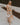 Full body front view of female model wearing a floral midi dress and cream block heels