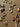 Picture of a flat lay of bag charms on a brown paper