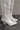 Close side view of the Sierra Cream Western Boots that feature cream faux-leather with monochromatic western stitching, inner zipper closures, pointed toes, and 2.5" cream heels.