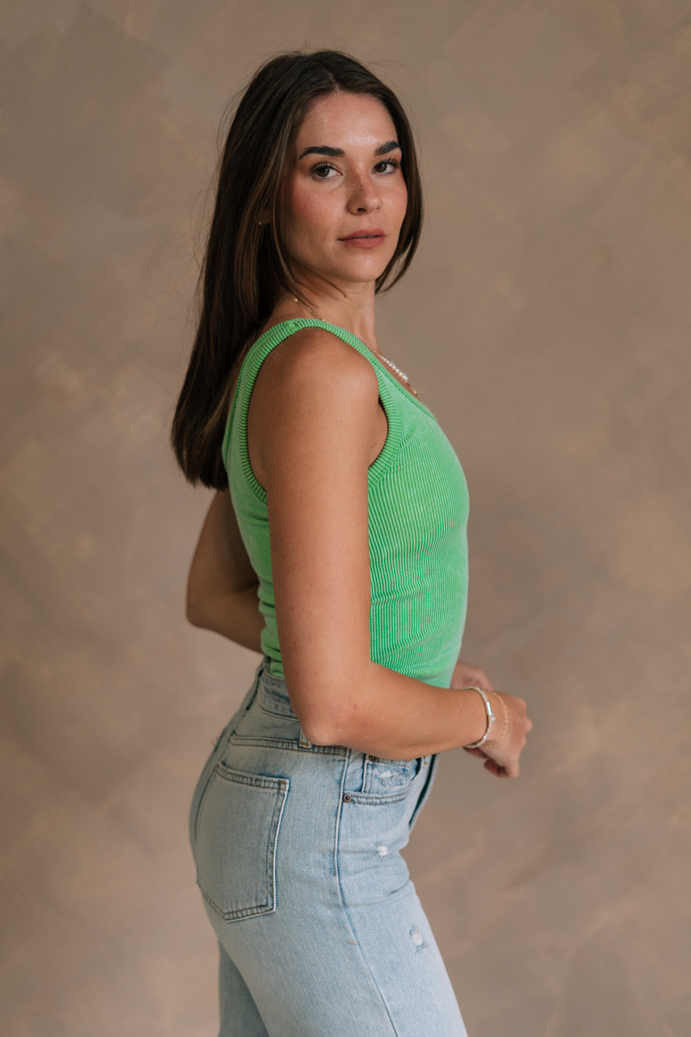 Side view of female model wearing the Kendall Ribbed Longline Brami in Green which features Ribbed Fabric, Washed Details, Longline Waist, Round Neckline, Thick Straps and Sleeveless.
