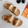 Ariel view of the Lyon Sandal in Beige Raffia which features natural raffia fabric, two adjustable velcro straps, adjustable back strap and round toe.