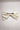 Image shows back of the Stacia Embellished Velvet Hair Bow in Ivory against a white background that features ivory velvet fabric with gold dot embellishments and a clasp closure.