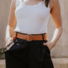 Front view of model wearing the Tiffany Black Shorts which features black fabric with black lining, a front zipper with hook closures, side pockets, faux back pocket details, belt loops, and front pleats.