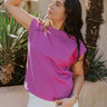 Front view of model wearing the Iris Orchid Purple Sleeveless Top which features orchid purple cotton fabric, round neckline and short sleeves with stitched ribbed hem details.