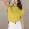 Front view of model wearing the Iris Chartreuse Sleeveless Top which features chartreuse cotton fabric, round neckline and short sleeves with stitch detail hem.