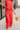 Front view of model wearing the Vada Red Wide Leg Pants that feature red woven fabric, side pockets, an elastic waistband, and flowy wide legs.