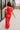 Full body back view of model wearing the Vada Red Wide Leg Pants that feature red woven fabric, side pockets, an elastic waistband, and flowy wide legs.