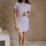 Full body front view of 5'6" female model wearing the Demi Tweed Short Sleeve Mini Dress in Purple that has light purple tweed fabric, short sleeves with puff shoulders, a high round neck, and back zipper.