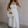 Full body view of female model wearing the Rebecca Off White Pearl Bow Midi Dress which featuresCream Sheer Fabric, Midi Length, Cream Lining, Strapless, Pearl Details and Bow Back Detail