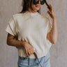 Front view of model wearing the Emma Cream Knit Short Sleeve Top which features Cream Knit Fabric, Ribbed Hem, Round Neckline and Short Sleeves.