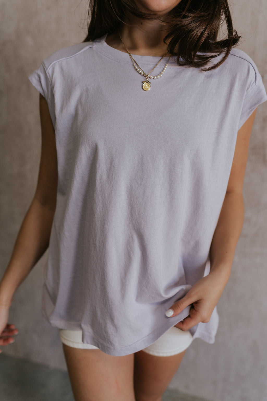 CLose up view of female model wearing the Khloe Lavender Short Sleeve Top which features Lavender Cotton Fabric, Round Neckline and Short Sleeves