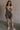 Full body view of female model wearing the Vera Washed Black Sleeveless Romper which features Washed Black Cotton Fabric, Two Side Pockets , V-Neckline, Sleeveless and Adjustable Straps