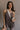 Front view of female model wearing the Vera Washed Black Sleeveless Romper which features Washed Black Cotton Fabric, Two Side Pockets , V-Neckline, Sleeveless and Adjustable Straps