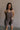Front view of female model wearing the Vera Washed Black Sleeveless Romper which features Washed Black Cotton Fabric, Two Side Pockets , V-Neckline, Sleeveless and Adjustable Straps