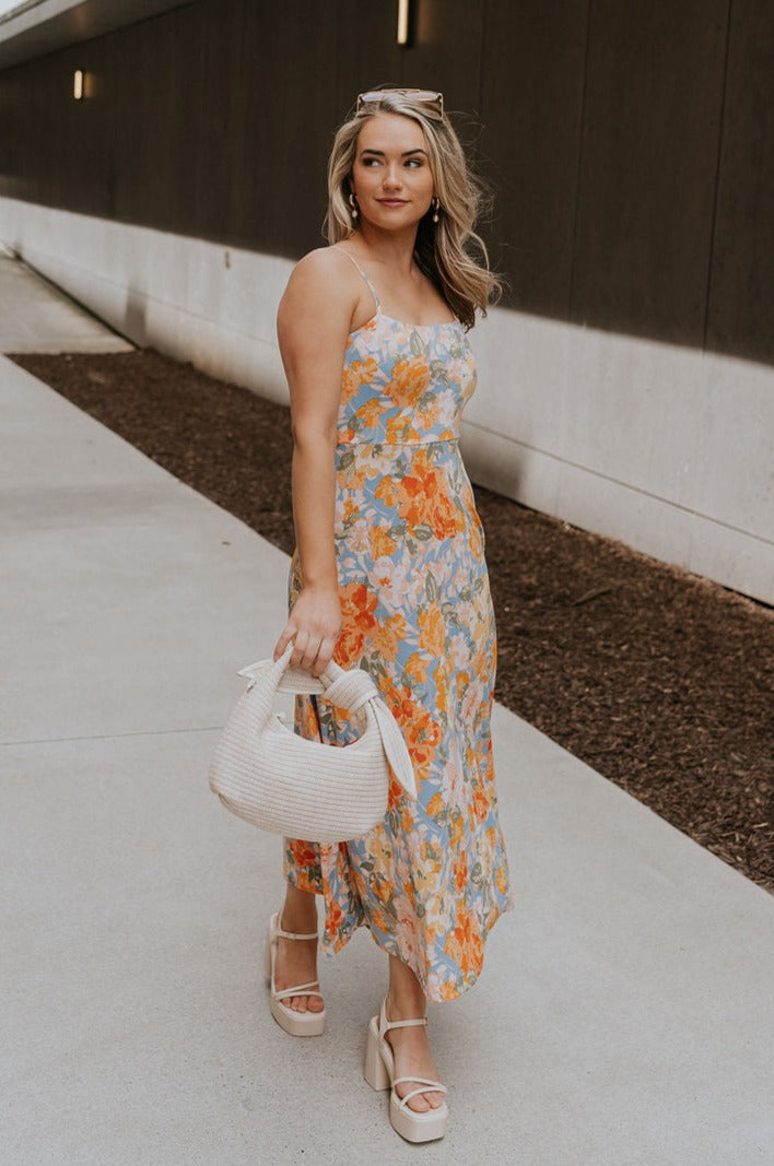 Full body view of female model wearing the Paislee Multi Floral Midi Dress which features Blue, Green, Orange, Pink, Red and Yellow Lightweight Fabric, Floral Pattern, Midi Length, Square Neckline and Adjustable Straps