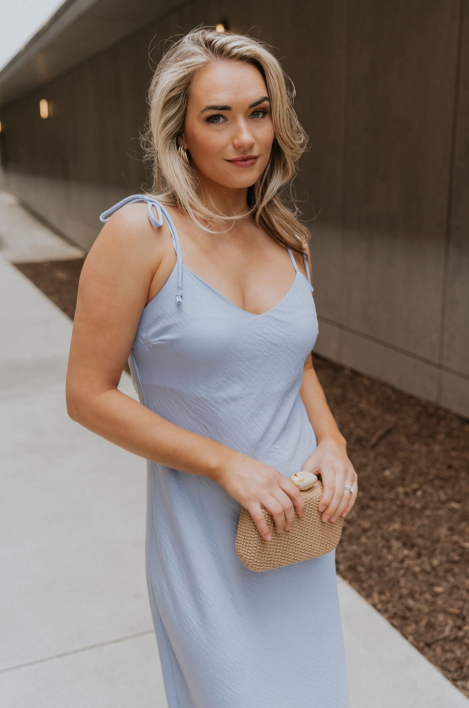 Front view of female model wearing the Colette Light Blue Midi Dress which features Light Blue Lightweight Fabric, Midi Length, V-Neckline and Tie Straps