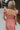 Back view of female model wearing the Allie Coral Pink Ruffle Midi Dress which features Coral Pink Lightweight Fabric, Midi Length, Coral Pink Lining, Ruffle Tier Skirt, Smocked Upper, Square Neckline, Ruffle Straps and Two Side Pockets