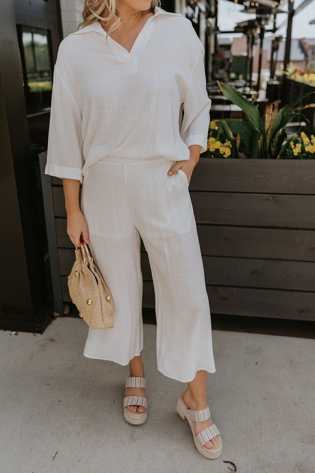 Front view of female model wearing the Rebecca Ivory Linen Cropped Pants which features Ivory Linen Fabric, Cropped Pant Legs, Ivory Lining, Two Side Pockets and Elastic Waistband