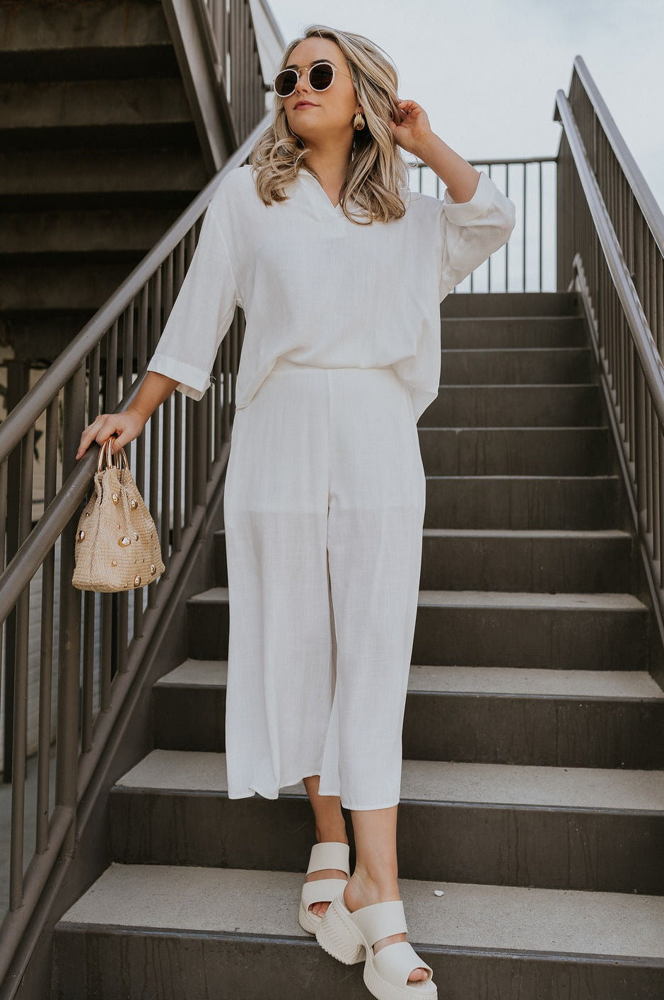 Full body view of female model wearing the ONA Streetworks Slide Heel Sandal in in Honey White & Sea Salt which features Cream Leather Lightweight Upper, Two Thick Straps, Slide-On Style, Traction Rubber Sole and 3" Heel, 1 1/14" Platform 