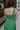 Back view of female model wearing the Selah Green Smocked Midi Dress which features Green Lightweight Fabric, Ruffle Tiered Body, Green Lining, Midi Length, Smocked Upper, Square Neckline and Thick Straps