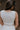 Back view of female model wearing the Hayden Cream & Mocha Tank which features Stretchy White Fabric, Taupe Side Colorblocking, Taupe Contrast Stitching, Square Neckline, Thick Straps and Cropped Waist