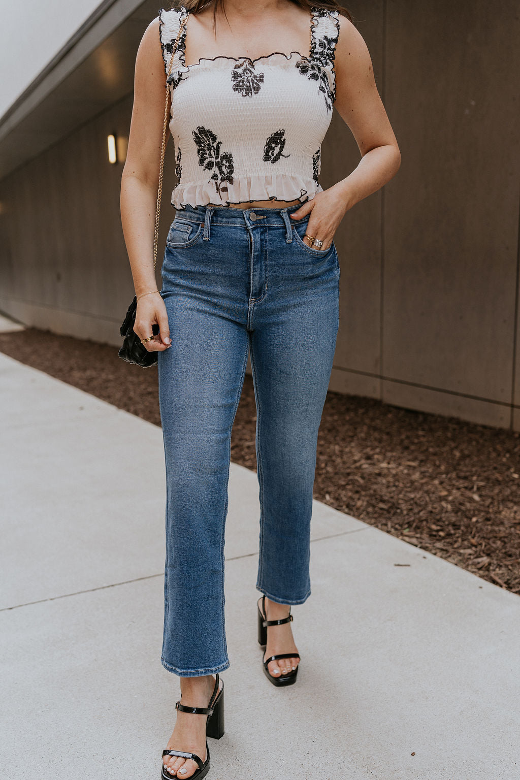 Front view of female model wearing the Journey Medium Denim Straight Leg Jeans which features Medium Denim Fabric, Straight Paint Leg, Two Front Pockets, Two Back Pockets, Front Zipper with Button Closure and Belt Loops
