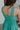 Back view of female model wearing the Vera Halter Cross Neckline Midi Dress in Green which features Lightweight Fabric, Lining, Midi Length, Side Ties Waistband, Halter Cross Neckline, Adjustable Straps and Sleeveless.