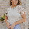 Front view of female model wearing the Brynlee Cream Crochet Scallop Top which features Cream Crochet Fabric, Cropped Waist, Round Neckline and Short Sleeves