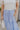 Close up front view of female model wearing the Alana Periwinkle Tiered Maxi Skirt which features Periwinkle Lightweight Fabric, Maxi Length, Periwinkle Thigh Length Lining, Tiered Body and Elastic Waistband with Drawstring Ties