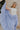 Front view of female model wearing the Alana Periwinkle Tiered Maxi Skirt which features Periwinkle Lightweight Fabric, Maxi Length, Periwinkle Thigh Length Lining, Tiered Body and Elastic Waistband with Drawstring Ties