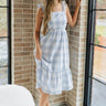 Full body view of female model wearing the Bonnie Light Blue and White Plaid Midi Dress which features Light Blue and White Plaid Design Midi Length, White Lining, Tiered Ruffle Hem, Square Neckline with Ruffle Straps and Sleeveless.