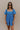 Front view of model wearing the Marissa Blue and White Floral Short Sleeve Romper which features Blue Lightweight Fabric, White Floral Design, Blue Lining, Square Neckline, Short Puff Sleeves and Smocked Back.
