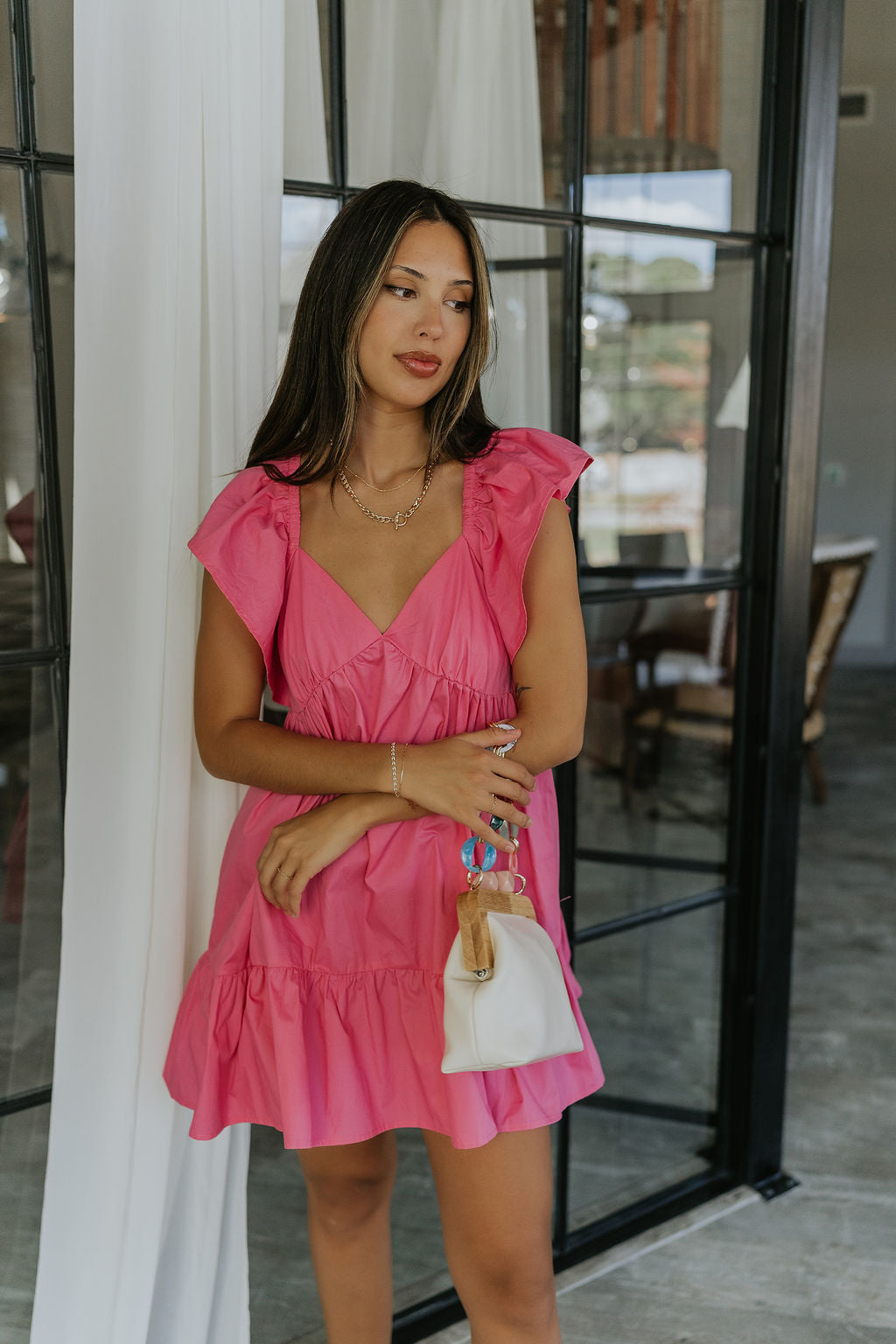 Front view of female model wearing the Alani Pink Ruffle Mini Dress which features Pink Lightweight Fabric, Mini Length, Ruffle Hem, Plunge Neckline and Ruffle Straps