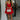full body front view of model wearing the Loretta Red Sleeveless Mini Dress that has a tiered skirt, surplice neckline, and thin straps. Worn with white heels and white purse.