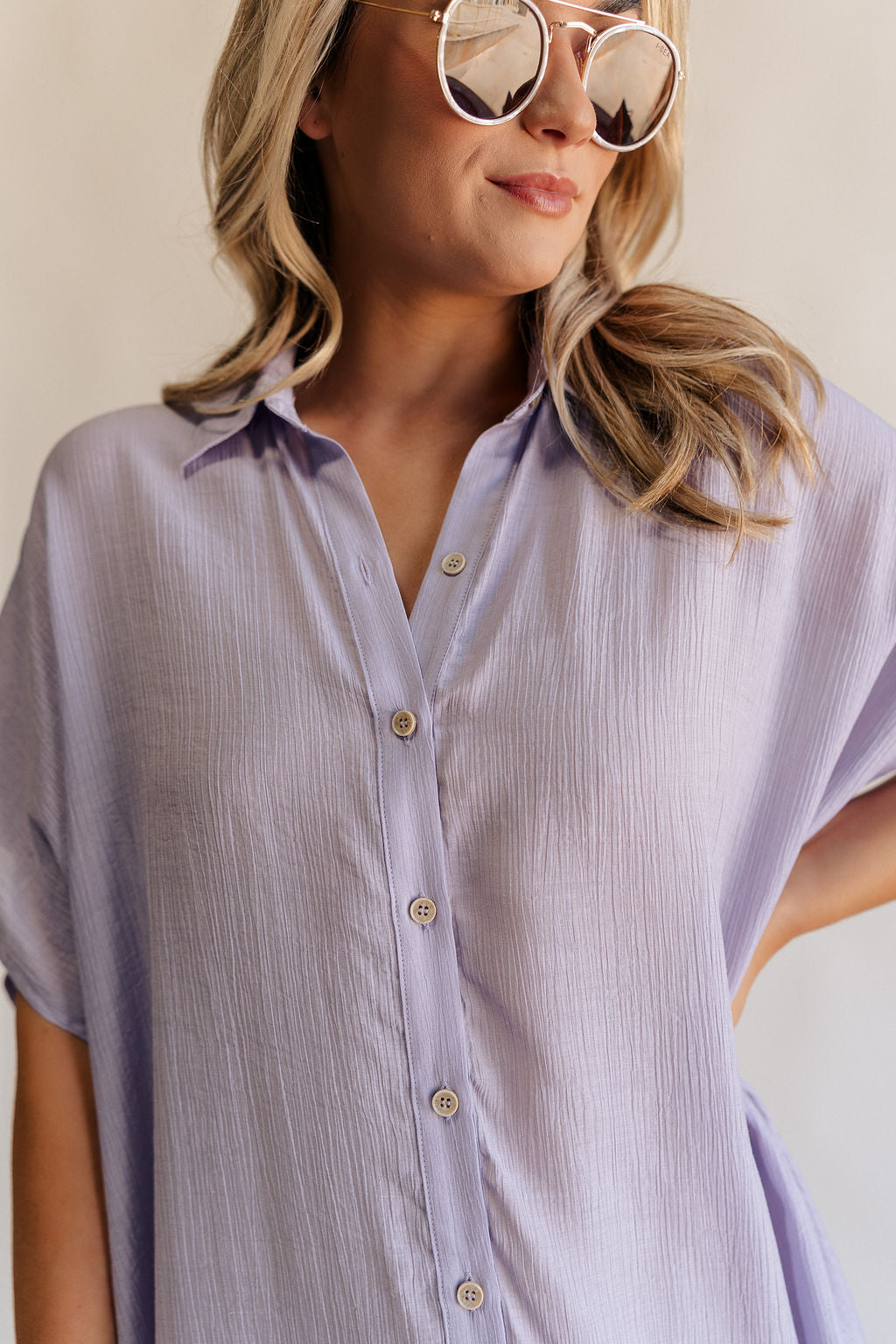 Close up front view of female model wearing the Luna Lavender Button-Up Short Sleeve Mini Dress which features Lavender Lightweight Fabric, Button-Up Front Closure, Collared Neckline and Short Sleeves