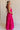  Full body side view of female model wearing the Luna Halter Tie Tiered Maxi Dress in Pink which features Lightweight Fabric, Tiered Body, Maxi Length, Thigh Length Lining, Halter Neckline with Tie and Open Back