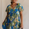 Front view of female model wearing the Tessa Blue & Lime Green Floral Mini Dress which features Blue, Green and White Light Weight Fabric, Floral Print, Mini Length, Tiered Body, Blue Lining, V-Neckline and Short Puff Sleeves