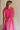 Back view of female model wearing the Cecilia Pink Smocked Midi Dress which features Pink Lightweight Fabric, Pink Lining, Pockets On Each Side, Midi Length, Textured Upper, Square Neckline and Sleeveless