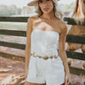 Front view of female model wearing the Saylor White Denim Strapless Romper which features Off White Denim Fabric, Light Brown Stitch Details, Two Front Pockets, Two Back Pockets, Belt Loops, Back Zipper and Strapless