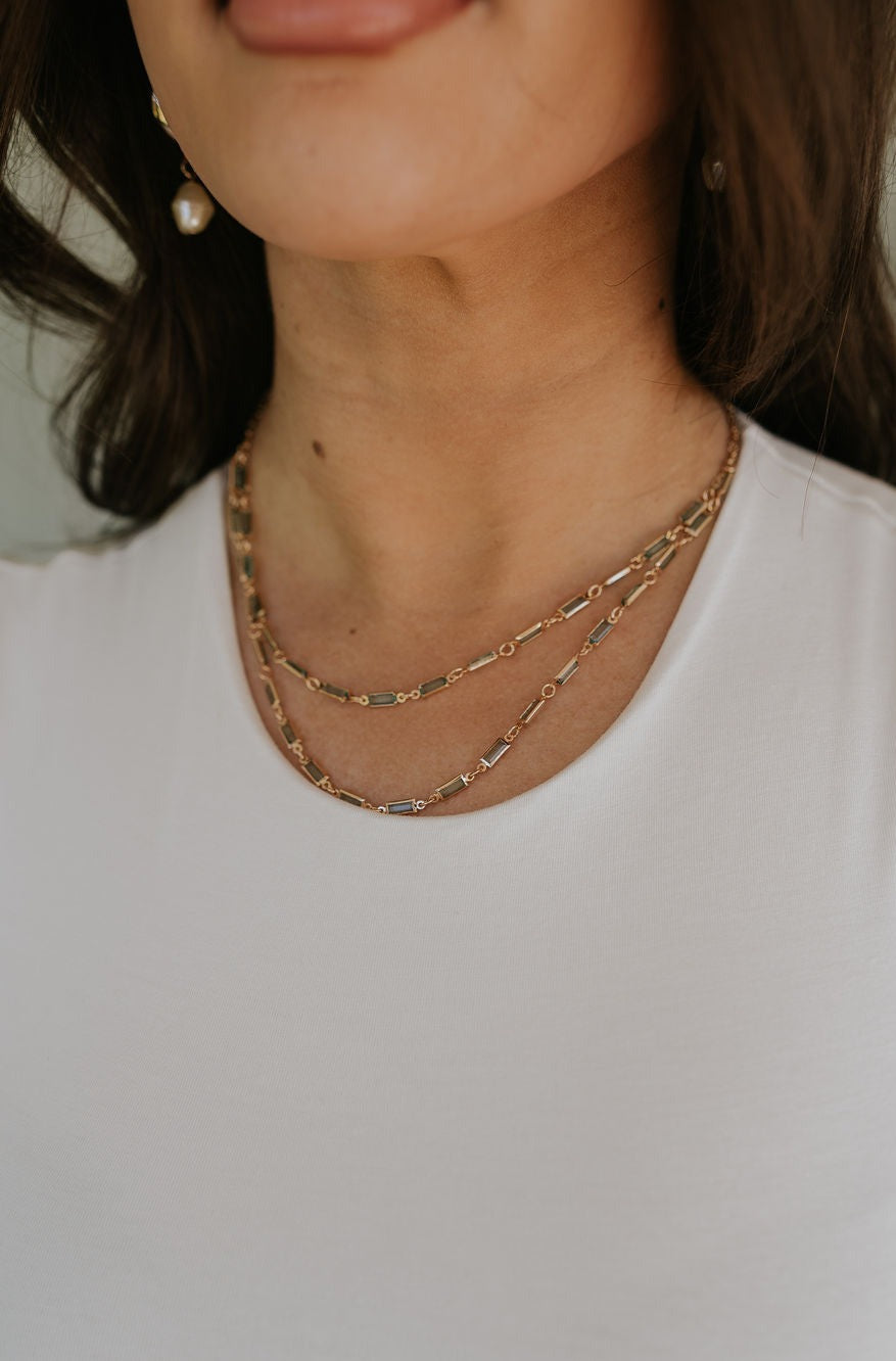Model is shown in a close-up wearing the Magdelene Necklace in mint.