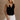Front view of female model wearing the Jasmine Black Button-Up Vest which features Black Linen Fabric, Monochrome Button Up Front Closure, Cropped Waist, V-Neckline and Sleeveless