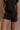 Front view of female model wearing the Kennedy Washed Black Drawstring Shorts which features Washed Black Cotton Fabric, Side Pockets and Elastic Waistband with Drawstring Tie