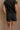 Back view of female model wearing the Kennedy Washed Black Drawstring Shorts which features Washed Black Cotton Fabric, Side Pockets and Elastic Waistband with Drawstring Tie