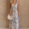 Full body view of female model wearing the Grace Blush Multi Floral Ruffle Maxi Dress which features Blush, Blue and Green Sheer Fabric, White Lining, Floral Print, Maxi Length, Ruffle Details, Plunge Neckline, Ruffle Straps and Open Back with Tie Detail