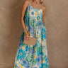 Full body view of female model wearing the Mallory Green Multi Floral Sleeveless Midi Dress which features Green, blue, white, and yellow floral print, Round neckline, Adjustable straps, Keyhole back with tie closure and White lining