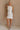 Full body view of female model wearing the Isla White Silver Ruched Halter Neckline Mini Dress which features White Silver Fabric, White Lining, Ruched Details, Overlap Hem, Halter Neckline and Monochrome Back Zipper with Hook Closure