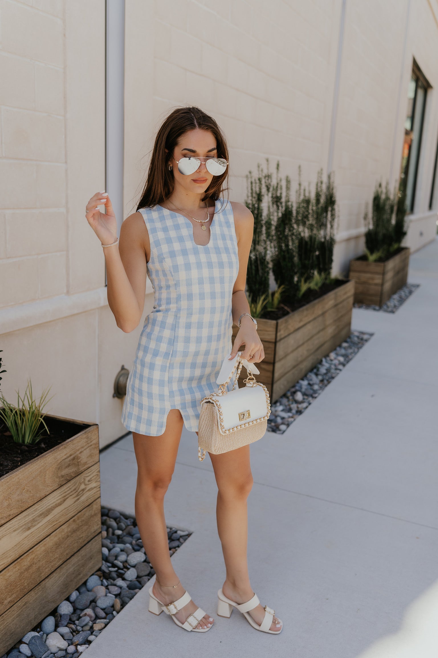image of model wearing blue and white plaid dress, link on image reads "shop dresses"