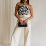 Full body view of female model wearing the Luna Natural & Black Belt Wide Leg Pants which features Cream Linen Fabric with Black Details, Side Pockets, Back Pockets, Wide Leg Pants, Monochrome Adjustable Buckle and Front Zipper with Hook Closure