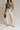front view of female model wearing the Luna Natural & Black Belt Wide Leg Pants which features Cream Linen Fabric with Black Details, Side Pockets, Back Pockets, Wide Leg Pants, Monochrome Adjustable Buckle and Front Zipper with Hook Closure